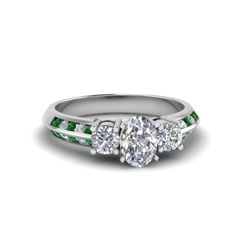 Oval Shaped 3 Stone Channel Accent Diamond Engagement Ring With Emerald